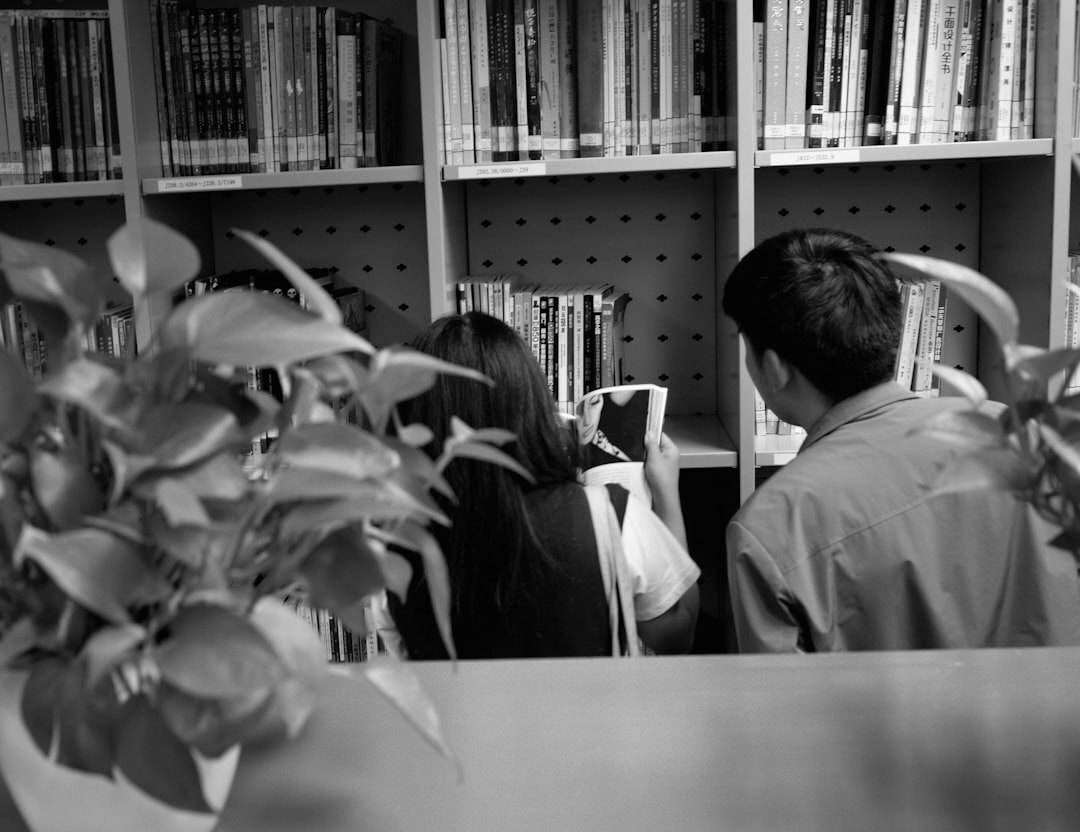 Small editorial team of journalists gathered around a desk reviewing archives